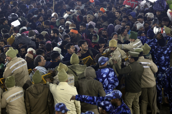 Security personnel try to control the pilgrims near the site of a stampede amid the ongoing Maha Kumbh Mela festival in Prayagraj on January 29, 2025.