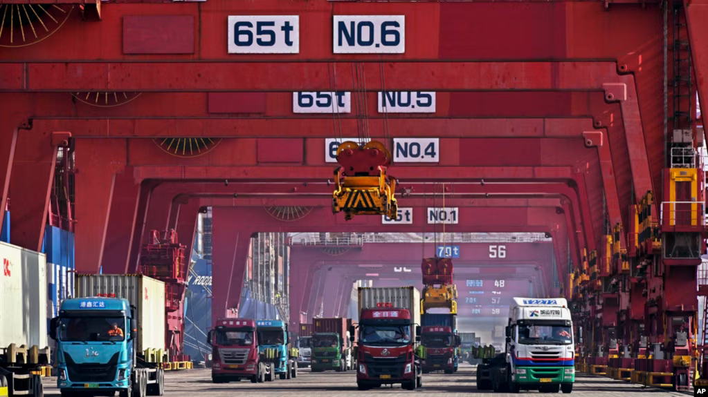 Containers are unloaded from a cargo ship at Qingdao Port, east China's Shandong Province, Feb. 11, 2024, in this photo released by Xinhua News Agency.