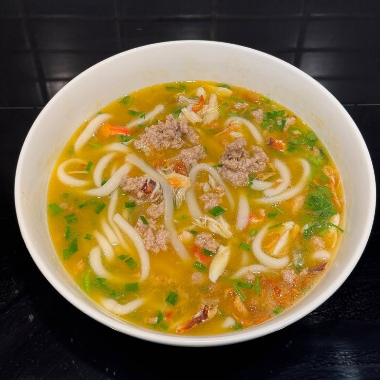 Tô bánh canh gạch cua nấu thịt bằm với sợi bánh canh dai mềm, nước dùng vàng óng, điểm xuyết hành ngò xanh mướt. Gạch cua và thịt cua hòa quyện cùng thịt xào tạo nên món ăn vừa ngọt thanh vừa béo bùi, cực kỳ bắt mắt.