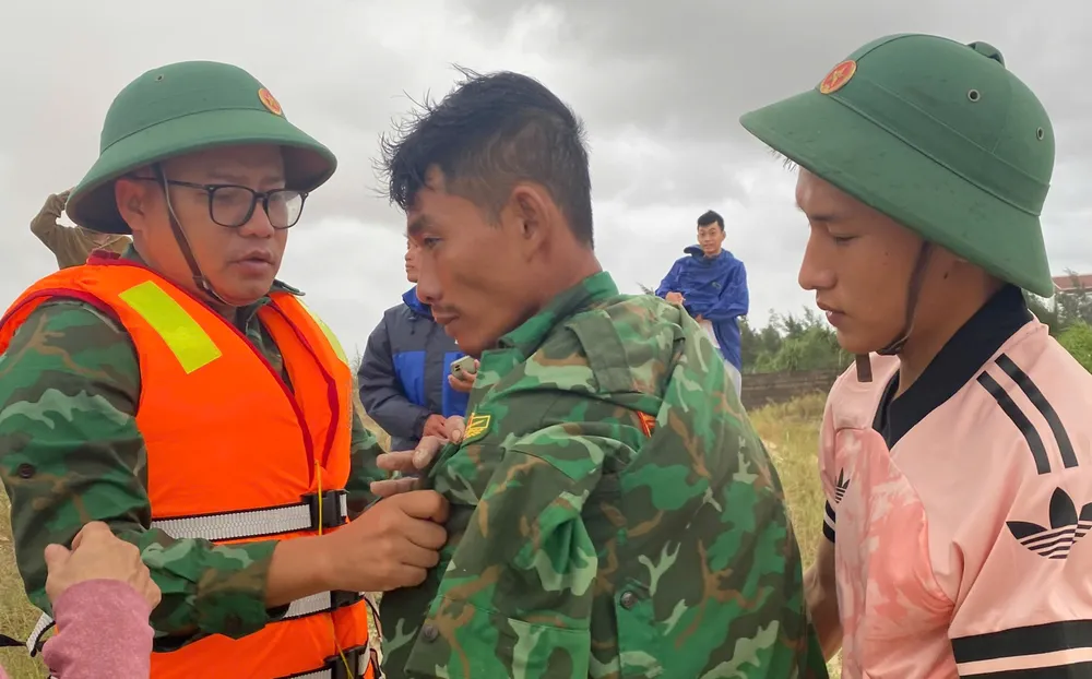 Trung tá Nguyễn Văn Anh, Chính trị viên Đồn Biên phòng cửa khẩu cảng Cửa Việt (bên phải) thăm hỏi thuyền viên tự bơi vào bờ. hai-tau-ca-tp-hcm-gap-nan-khi-vao-tru-bao- o-quang-tri-1-thuyen-vien-da-vao-bo1.jpg