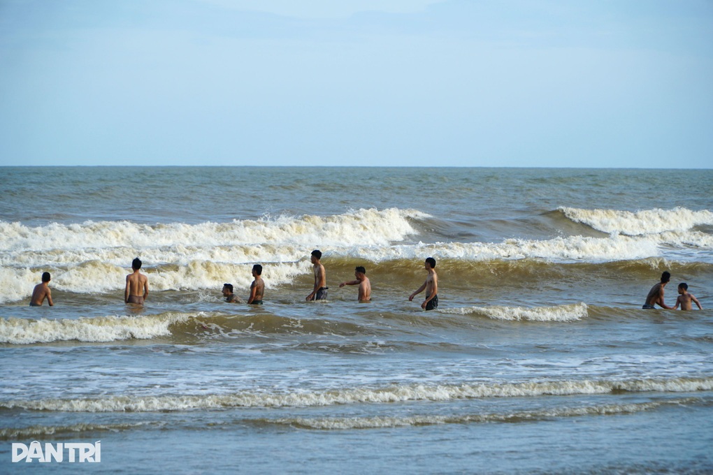 Du khách tắm biển Sầm Sơn trước giờ bão Bualoi đổ bộ đất liền - 1