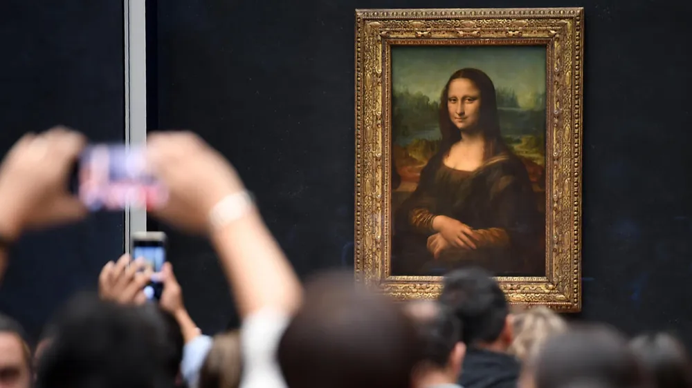 Bức họa Mona Lisa tại Bảo tàng Louvre. Ảnh: Eric Feferberg/AFP Bao-tang-Louvre.jpg