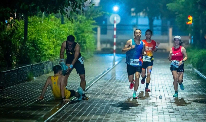 Một runner bị chuột rút được chăm sóc trên đường đua 42km giải Standard Chartered Hanoi Marathon Heritage 2025 ngày 9/11. Ảnh: Standard Chartered Hanoi Marathon Heritage