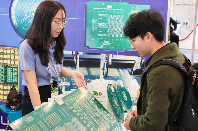 Khách tham quan đang xem một bảng mạch in tại triển lãm Semi Expo 2005. Ảnh: Trọng Đạt