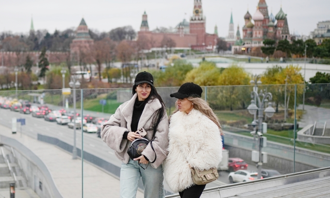 Hai cô gái đi bộ ở công viên Zaryadye tại trung tâm thủ đô Moskva, phía xa là Điện Kremlin, ngày 14/11. Ảnh: AP