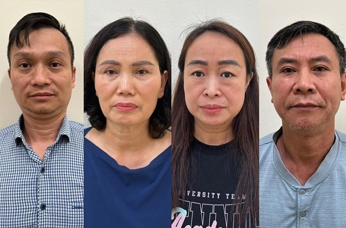 Bị can Đinh Quang Minh, Nguyễn Thị Minh Hải, Lê Thị Hiên, Cao Văn Trung (từ trái qua phải) tại cơ quan điều tra. Ảnh: Bộ Công an