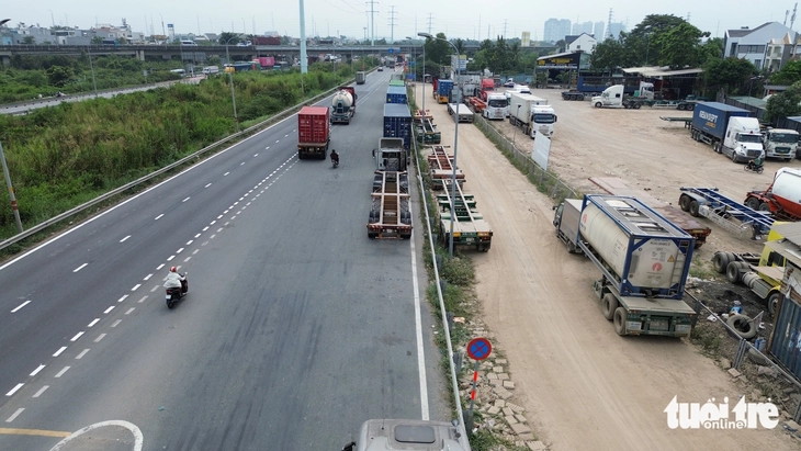 Xe đầu kéo, container đậu hàng dài trên đường dẫn cao tốc, hướng ra đường Võ Chí Công dù có biển cấm - Ảnh 4.