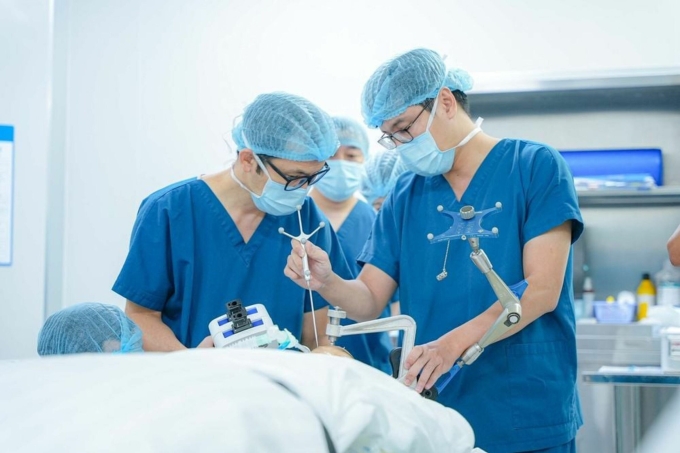 Ê-kíp bác sĩ đang chuẩn bị đưa điện cực vào sọ não, điều trị cho bệnh nhân 9 tuổi mắc động kinh kháng trị. Ảnh: Vinmec