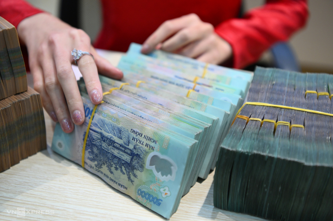 Nhân viên ngân hàng đang kiểm đếm tiền gửi của khách. Ảnh: Giang Huy