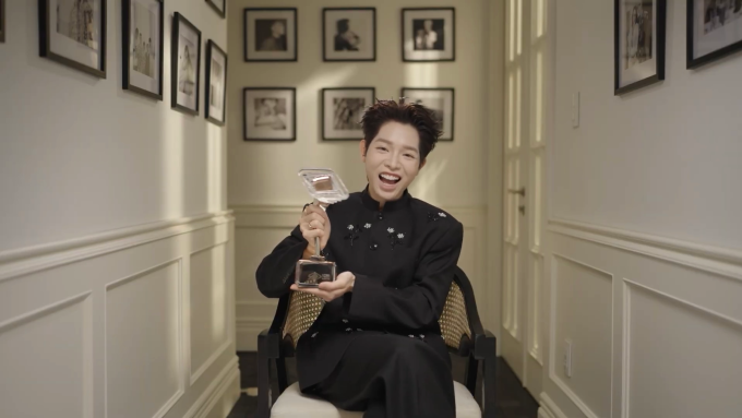 Đức Phúc bên chiếc cúp vô địch khi ngồi kể lại quá trình chinh phục Intervision trong phim.