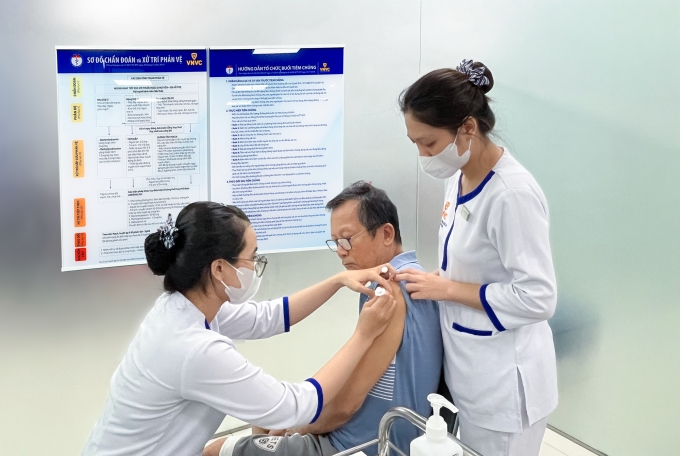 Ông Phạm Văn Bảo và vợ cùng tiêm vaccine RSV, phế cầu, cúm tại Hệ thống Tiêm chủng VNVC. Ảnh: Diệu Thuần