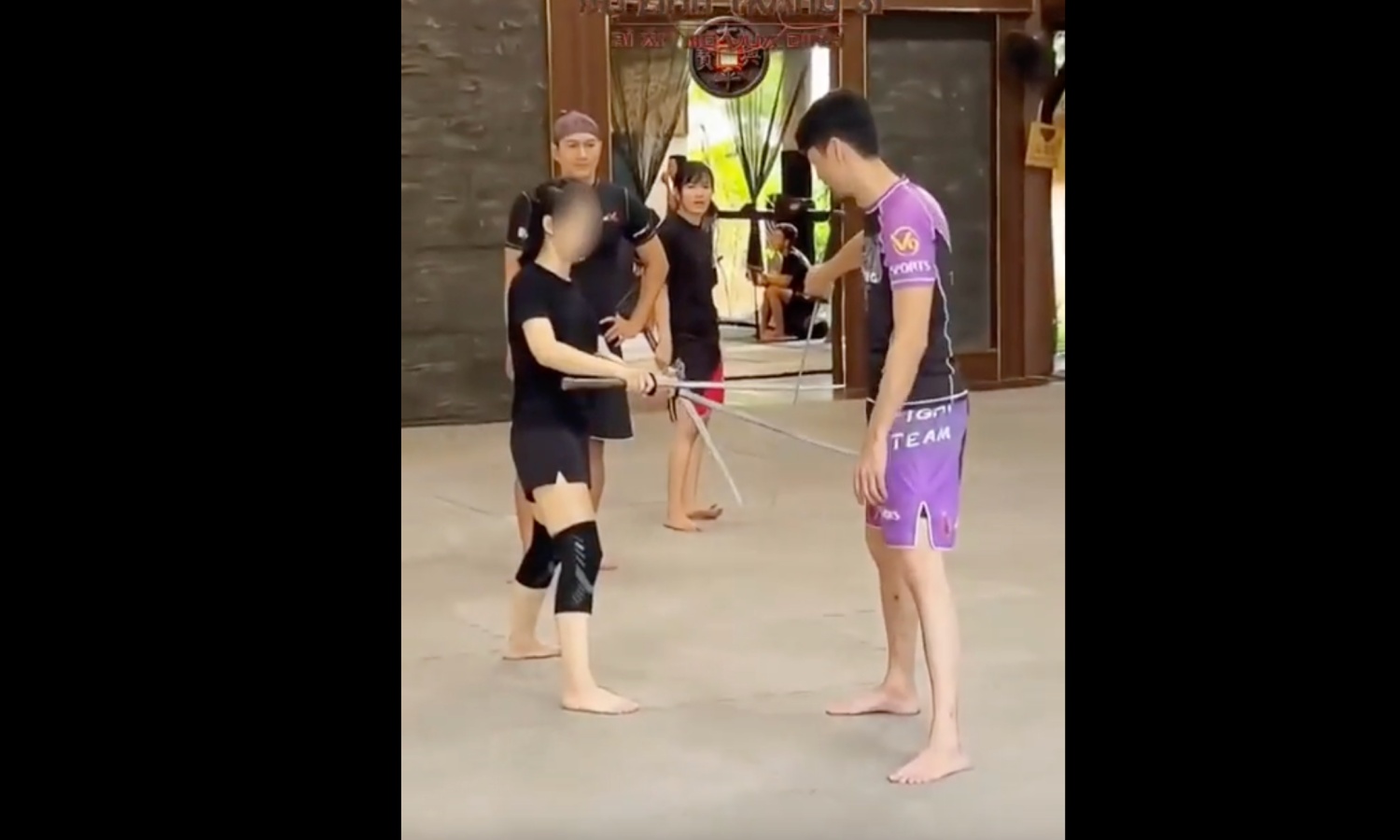 Johnny Trí Nguyễn hướng dẫn diễn viên tập luyện với gươm ở võ đường