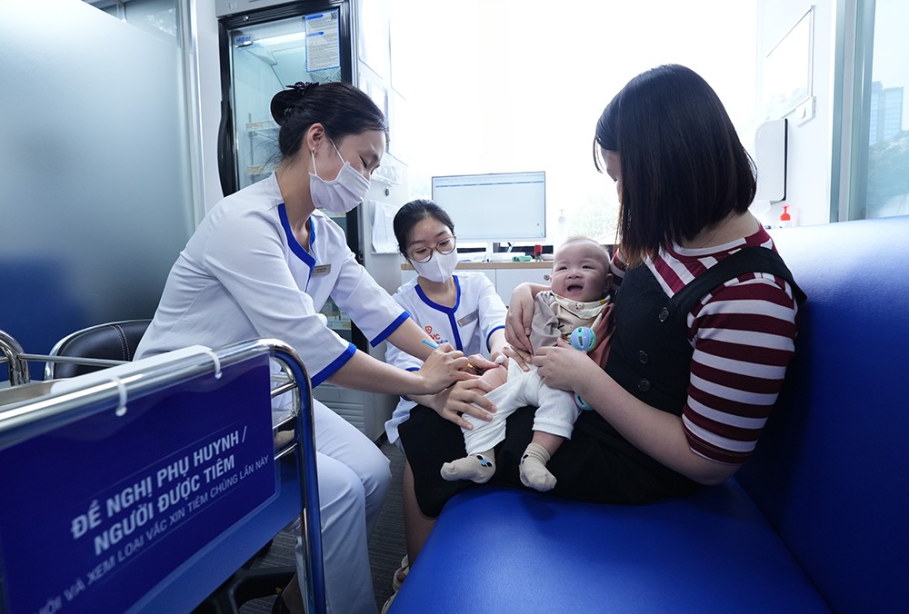 Phụ huynh đưa trẻ đi tiêm chủng phòng ngừa bệnh do virus hợp bào hô hấp RSV tại Hệ thống Tiêm chủng VNVC. Ảnh: Tuấn Anh