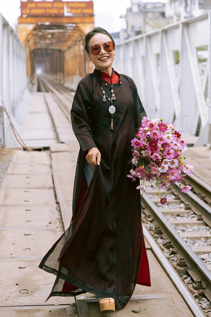 Mốt áo dài du xuân năm Ngựa 14 Diễn viên Tú Oanh phối áo tà kép của Cao Minh Tiến với quần jeans và giày platform khi đi chơi trên cầu ở Long Biên.