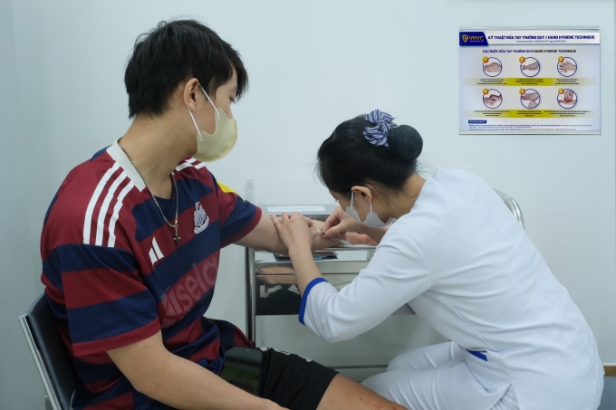Điều dưỡng đang tiêm huyết thanh ở cánh tay để test cho Kim. Ảnh: Hoàng Dương