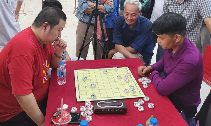 Vương Hạo (trái) trong một ván đấu tại giải cờ tướng hội làng Đông Lao, xã An Khánh, Hà Nội ngày 2/3/2026. Ảnh: Nhất Chi Mai