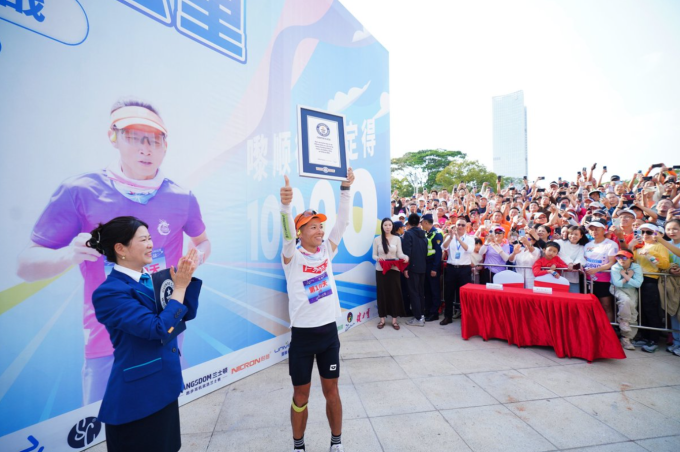 Rồi giơ cao tấm bằng chứng nhận kỷ lục Guinness sau khi hoàn thành thử thách chạy 100 km mỗi ngày trong 100 ngày liên tiếp. Ảnh: Guinness