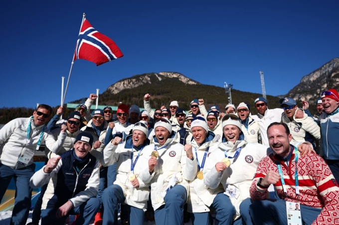Norways gold medal-winning cross country team celebrates with staff members after the mens 4 x 7.5-kilometer relay at the Milano Cortina Games in Lago, Italy, on Sunday. | REUTERS